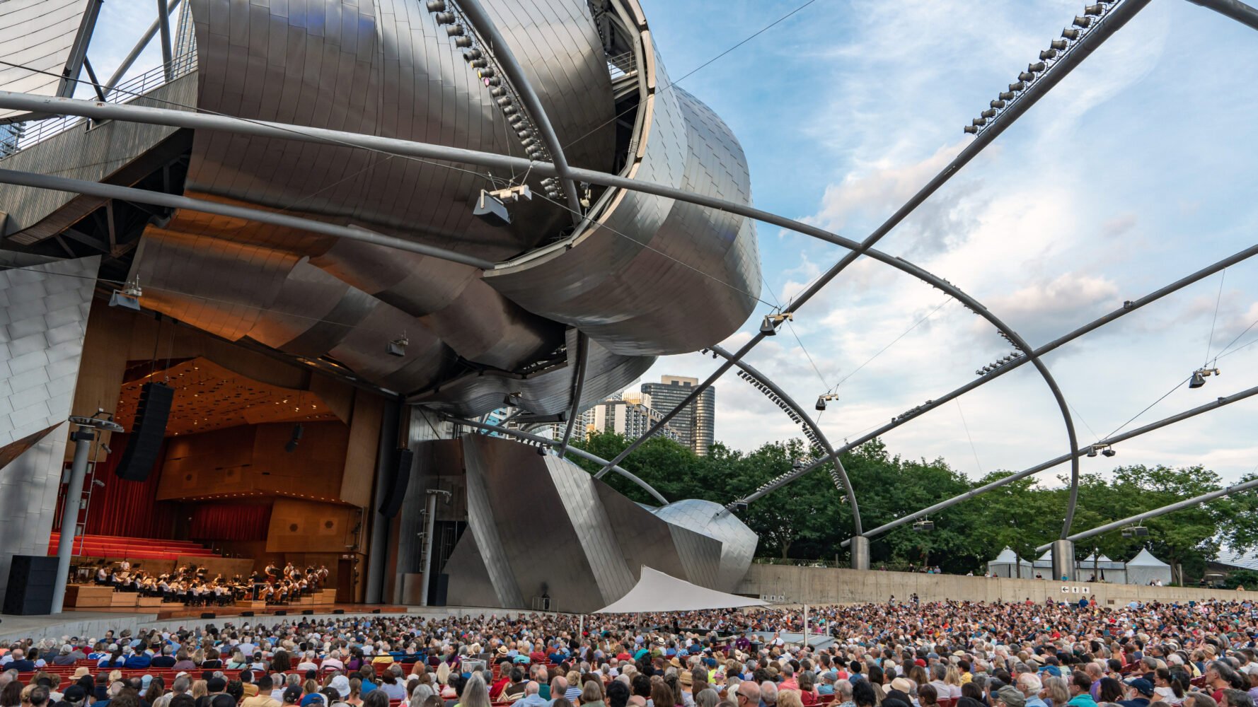 the GRant Park Orchestra performs on the striking Pritzker Pavilion stage to a full audience