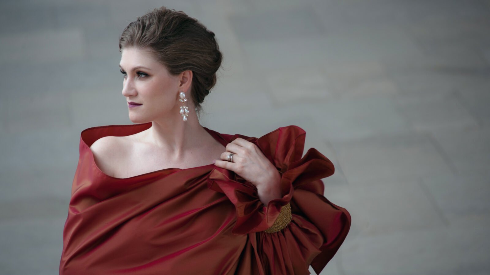 Jane Archibald looks into the distance in a lavish red wrap